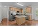 Bright kitchen with stainless steel appliances, granite countertops, and an island at 2 Piney Ridge Ct, Durham, NC 27712