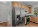 Updated kitchen featuring stainless steel appliances, wood cabinets, and granite countertops at 2 Piney Ridge Ct, Durham, NC 27712