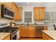 Bright kitchen with stainless steel appliances, granite counters, and a window view at 2 Piney Ridge Ct, Durham, NC 27712
