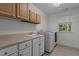 Bright laundry room with sink, counter, storage and new front load washer and dryer at 2 Piney Ridge Ct, Durham, NC 27712
