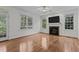 Spacious living room with hardwood floors, fireplace, and access to the backyard at 2 Piney Ridge Ct, Durham, NC 27712