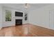 Bright living room features fireplace, hardwood floors, and plenty of natural light at 2 Piney Ridge Ct, Durham, NC 27712