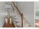 Elegant staircase with carpeted steps and white railings leading to the upper level at 2 Piney Ridge Ct, Durham, NC 27712