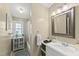 Bright bathroom with vanity and mirror and a shower/tub combination at 205 W Moore St, Apex, NC 27502