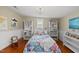 Bright and colorful bedroom with hardwood floors and white trim at 205 W Moore St, Apex, NC 27502