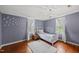 Charming bedroom with accent wall, white curtains, and hardwood floors at 205 W Moore St, Apex, NC 27502