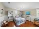 Colorful bedroom with hardwood floors, bright textiles, and classic decor at 205 W Moore St, Apex, NC 27502