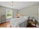 Inviting bedroom with hardwood floors, neutral walls, and a classic lamp at 205 W Moore St, Apex, NC 27502