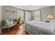 Cozy bedroom with hardwood floors, bright windows, and comfortable furniture at 205 W Moore St, Apex, NC 27502