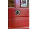 Close-up of a vintage red door with antique hardware at 205 W Moore St, Apex, NC 27502
