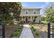 Charming two-story home featuring a welcoming front porch with swing and meticulous landscaping at 205 W Moore St, Apex, NC 27502