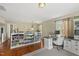 Home office with hardwood floors, modern desk, built in cabinets, and large television at 205 W Moore St, Apex, NC 27502