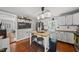 Bright kitchen with stainless steel appliances and an island with seating, under modern lighting at 205 W Moore St, Apex, NC 27502