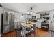 Charming kitchen with stainless steel appliances, an island with seating and modern lighting at 205 W Moore St, Apex, NC 27502