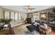 Inviting living room with a comfortable leather chair, antique decor, and abundant natural light at 205 W Moore St, Apex, NC 27502