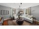 Cozy living room with natural light, hardwood floors, and comfortable seating at 205 W Moore St, Apex, NC 27502