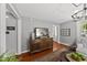 Cozy living room with hardwood floors, a decorative media cabinet and natural light at 205 W Moore St, Apex, NC 27502