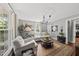 Bright living room features hardwood floors, natural light, and comfortable seating arrangements at 205 W Moore St, Apex, NC 27502