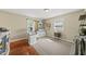 Home office featuring hardwood floors, built-in shelving, and lots of natural light at 205 W Moore St, Apex, NC 27502