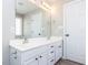 Bathroom featuring double sink vanity with white cabinetry and framed mirror at 211 Milky Way Dr, Apex, NC 27502