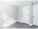 Neutral bedroom featuring modern gray flooring, a ceiling fan, and bright white trim at 211 Milky Way Dr, Apex, NC 27502