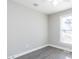 Neutral bedroom with gray flooring, a ceiling fan, and natural light from large window at 211 Milky Way Dr, Apex, NC 27502
