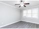 This bedroom features modern gray flooring and a ceiling fan for added comfort at 211 Milky Way Dr, Apex, NC 27502