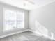 Sun-filled bedroom with modern gray flooring and a large window with natural light at 211 Milky Way Dr, Apex, NC 27502