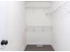 Walk-in closet with white wire shelving and modern gray flooring at 211 Milky Way Dr, Apex, NC 27502
