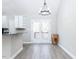 Dining area with wood floors, chandelier lighting, access to back deck, and views into kitchen at 211 Milky Way Dr, Apex, NC 27502