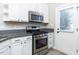 Well-lit kitchen features stainless steel appliances, granite countertops, and white cabinetry at 211 Milky Way Dr, Apex, NC 27502