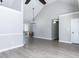 Open-concept living room with wood floors, vaulted ceilings, a modern light fixture, and access to the back deck at 211 Milky Way Dr, Apex, NC 27502