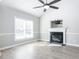 A bright living room featuring a fireplace, high ceilings, wood floors and a ceiling fan at 211 Milky Way Dr, Apex, NC 27502
