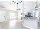 Open living space with wood floors, vaulted ceilings, and views into the kitchen with granite countertops at 211 Milky Way Dr, Apex, NC 27502