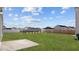 A large, grassy backyard with a concrete slab and privacy fence at 230 Bay Laurel Dr, Sanford, NC 27330