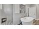 Bright bathroom with a modern soaking tub, glass-enclosed shower and white subway tile at 2432 Spindle Ct, Raleigh, NC 27603
