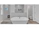 Elegant bathroom features a soaking tub, tiled shower, and a toilet in a separate room at 2432 Spindle Ct, Raleigh, NC 27603