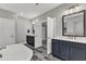 Elegant bathroom features double vanities, a soaking tub, and an open doorway to the bedroom at 2432 Spindle Ct, Raleigh, NC 27603