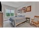 A serene bedroom features neutral walls, plush carpeting, a bright window, and nature-inspired wall art at 2432 Spindle Ct, Raleigh, NC 27603