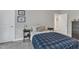 Cozy bedroom with carpeted floors, a plaid duvet, and gray walls at 2432 Spindle Ct, Raleigh, NC 27603
