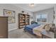 Cozy bedroom features a bookshelf, a map of the world, and a leather armchair at 2432 Spindle Ct, Raleigh, NC 27603