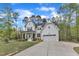 Newly constructed farmhouse with a two-car garage, white siding, black shutters, and a manicured lawn at 2432 Spindle Ct, Raleigh, NC 27603