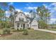 Charming new construction farmhouse with white siding, black shutters, a two-car garage, and a lovely front yard at 2432 Spindle Ct, Raleigh, NC 27603