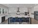 A stunning kitchen features a large island with barstool seating, white cabinets, and stainless steel appliances at 2432 Spindle Ct, Raleigh, NC 27603
