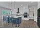 Kitchen island with seating and pendant lights, lots of storage, and stainless steel appliances at 2432 Spindle Ct, Raleigh, NC 27603