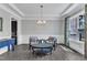 Bright and airy living room with classic trim, hardwood floors, and modern furnishings, illuminated by chandelier at 2432 Spindle Ct, Raleigh, NC 27603