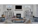 Cozy living room featuring a fireplace, built-in shelving, and neutral decor at 2432 Spindle Ct, Raleigh, NC 27603