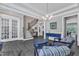 Spacious living room with hardwood floors, leading to staircase, with modern furniture and stylish light fixtures at 2432 Spindle Ct, Raleigh, NC 27603