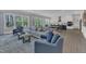 Open-concept living room with hardwood floors, view to the kitchen, and lots of natural light at 2432 Spindle Ct, Raleigh, NC 27603