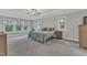 Expansive main bedroom with a tray ceiling, plush carpeting, and large windows with scenic outdoor views at 2432 Spindle Ct, Raleigh, NC 27603
